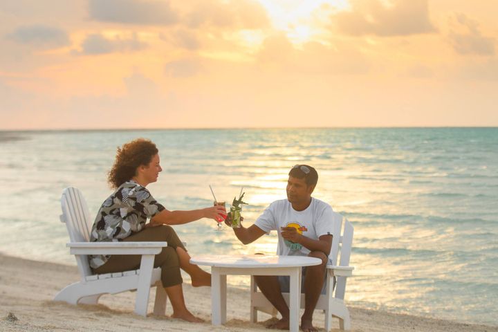 Beachside dinner setting at sunset, Maldives